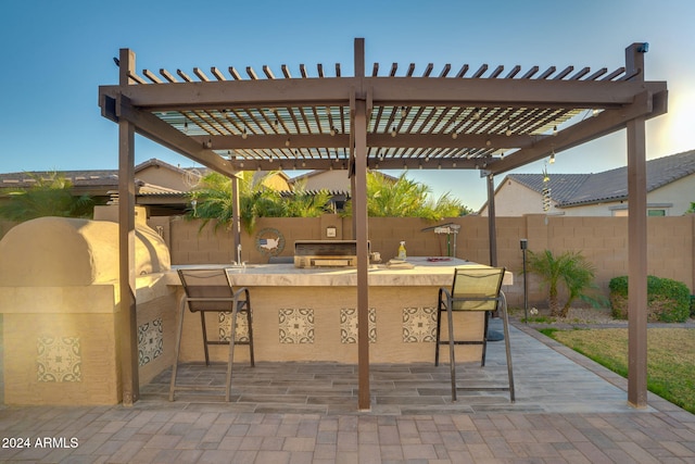 view of patio featuring exterior bar, a pergola, and area for grilling