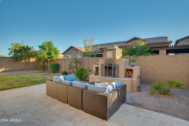 view of patio / terrace with an outdoor living space with a fireplace