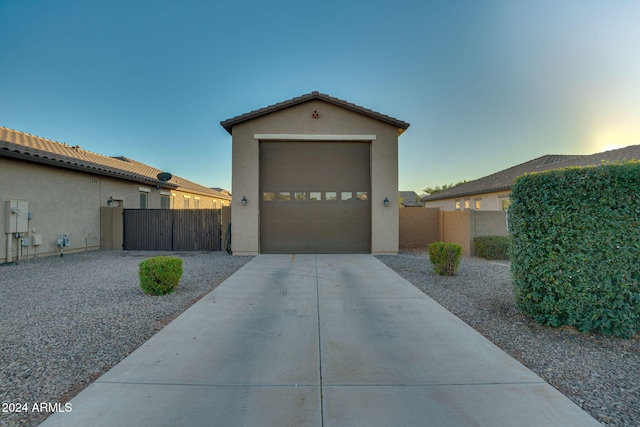 exterior space featuring a garage and an outbuilding