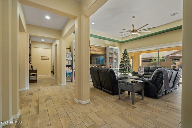 living room with ceiling fan and light hardwood / wood-style flooring