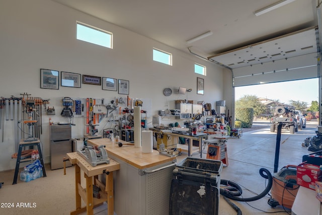 garage featuring a workshop area and stainless steel refrigerator