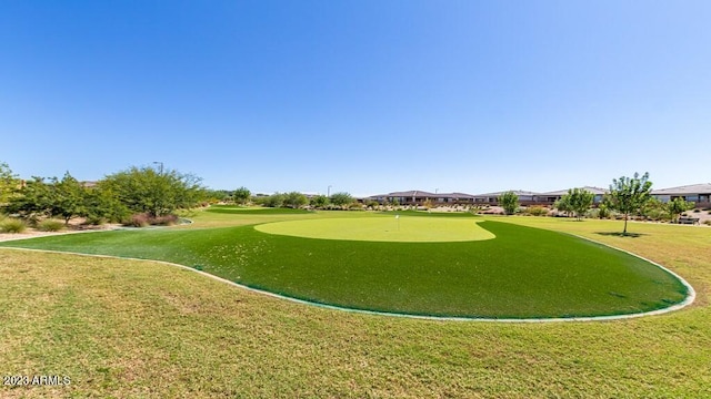 view of home's community with a yard and view of golf course