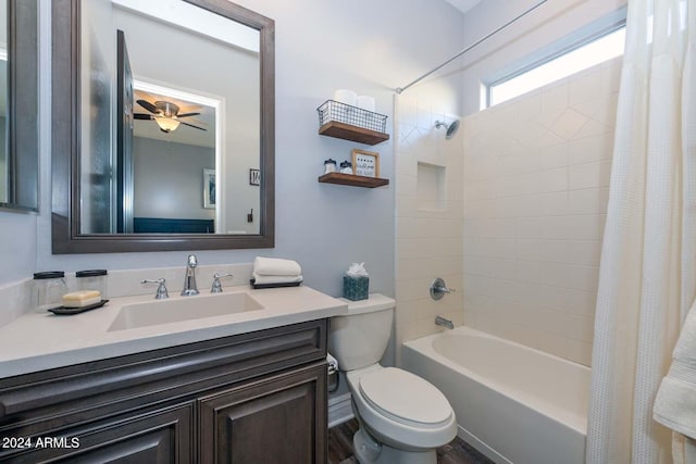 full bathroom with ceiling fan, vanity, shower / bath combo with shower curtain, and toilet