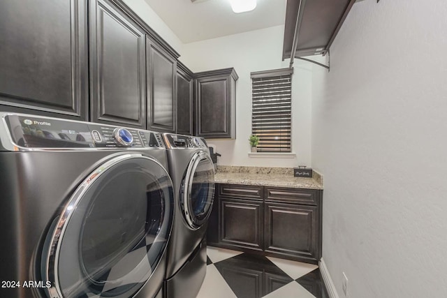 laundry area featuring washing machine and dryer and cabinets