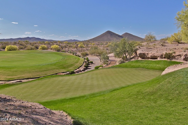 view of community featuring a lawn and a mountain view