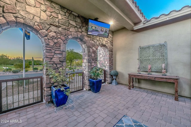 view of patio terrace at dusk