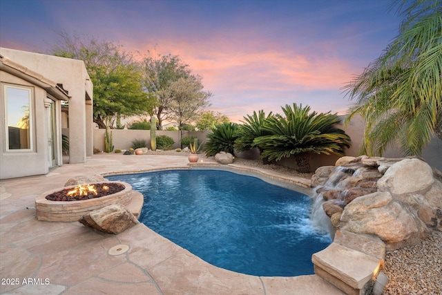 view of swimming pool with a fenced backyard, an outdoor fire pit, a fenced in pool, and a patio