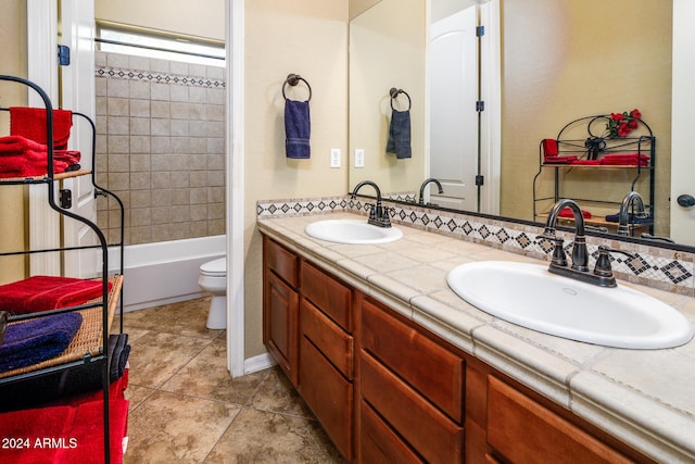 full bathroom with vanity, toilet, and tiled shower / bath combo