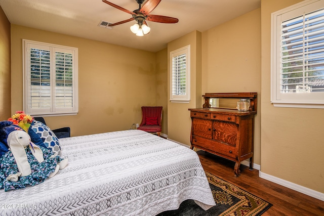 bedroom with ceiling fan and dark hardwood / wood-style floors