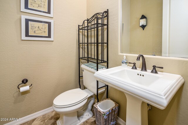 bathroom featuring toilet and sink