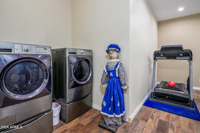 laundry room featuring dark hardwood / wood-style flooring and washing machine and dryer