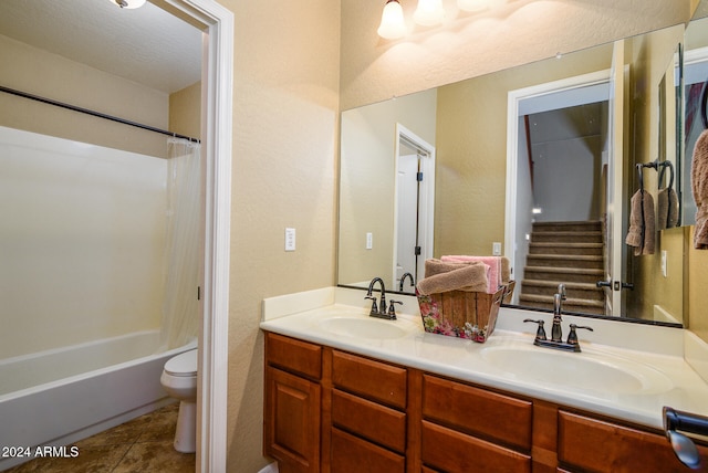 full bathroom featuring tile patterned floors, toilet, a textured ceiling, vanity, and bathing tub / shower combination