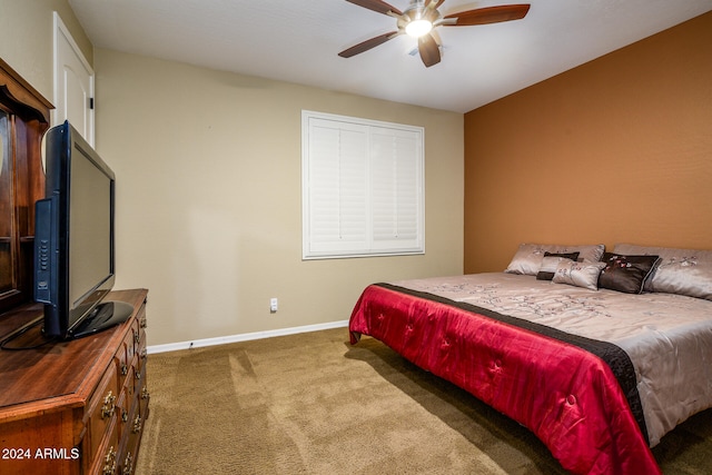 bedroom with ceiling fan and dark colored carpet