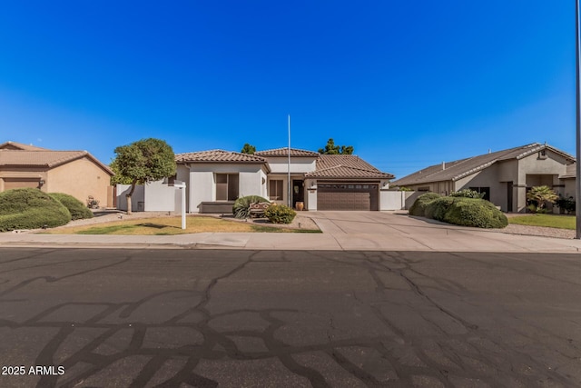 10529 E Posada Ave, Mesa, AZ 85212 - view of front of home with a tile roof, an attached garage, stucco siding, and concrete driveway