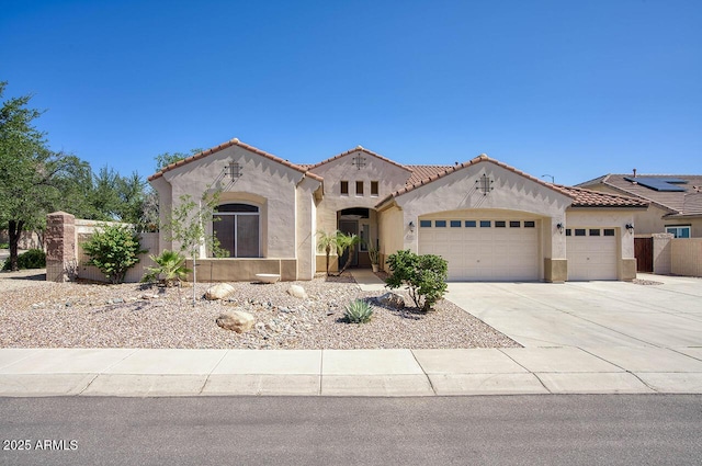 8068 W Carlota Ln, Peoria, AZ 85383 - mediterranean / spanish house with an attached garage, stucco siding, concrete driveway, and a tiled roof