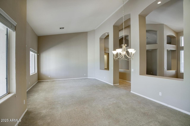 8068 W Carlota Ln, Peoria, AZ 85383 - carpeted spare room with a chandelier, plenty of natural light, built in shelves, and arched walkways