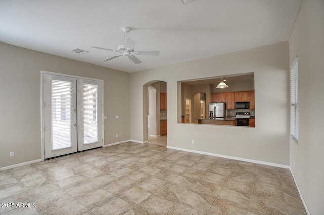 8068 W Carlota Ln, Peoria, AZ 85383 - unfurnished living room with arched walkways, ceiling fan, and french doors