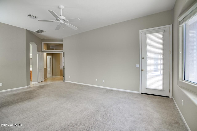 8068 W Carlota Ln, Peoria, AZ 85383 - empty room with ceiling fan, light colored carpet, healthy amount of natural light, and arched walkways