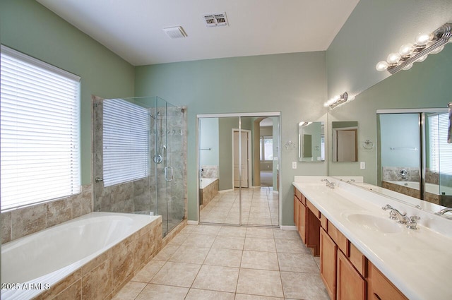 8068 W Carlota Ln, Peoria, AZ 85383 - bathroom with double vanity, a bath, a stall shower, and tile patterned flooring