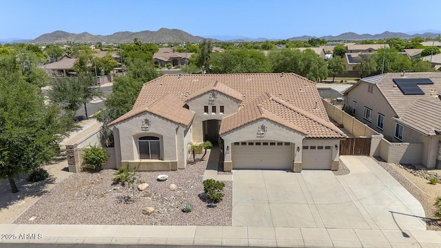 8068 W Carlota Ln, Peoria, AZ 85383 - mediterranean / spanish house featuring an attached garage, a tile roof, driveway, and stucco siding