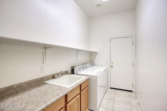 8068 W Carlota Ln, Peoria, AZ 85383 - laundry area with washer and dryer, light tile patterned flooring, and cabinet space
