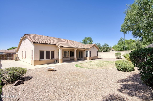 8068 W Carlota Ln, Peoria, AZ 85383 - back of property featuring a tile roof, stucco siding, a fenced backyard, and a patio area