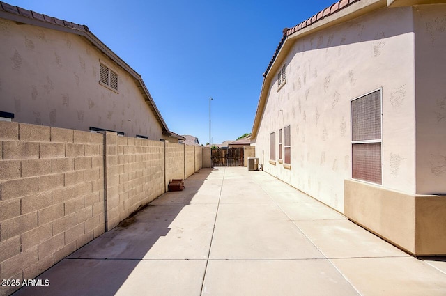 8068 W Carlota Ln, Peoria, AZ 85383 - view of side of property with a fenced backyard, stucco siding, a patio area, and a tiled roof