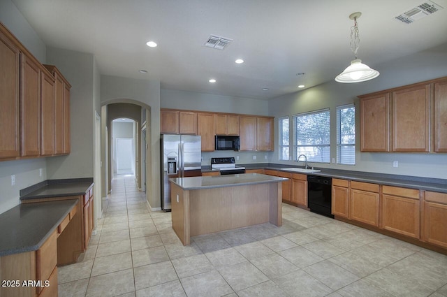 8068 W Carlota Ln, Peoria, AZ 85383 - kitchen with black appliances, arched walkways, recessed lighting, a kitchen island, and light tile patterned floors