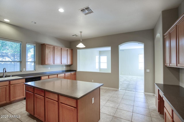 8068 W Carlota Ln, Peoria, AZ 85383 - kitchen featuring arched walkways, light tile patterned floors, a center island, recessed lighting, and hanging light fixtures
