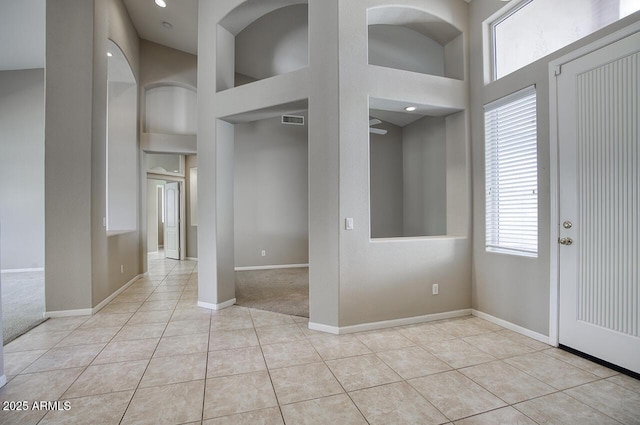 8068 W Carlota Ln, Peoria, AZ 85383 - entryway with light tile patterned floors, a towering ceiling, and light colored carpet