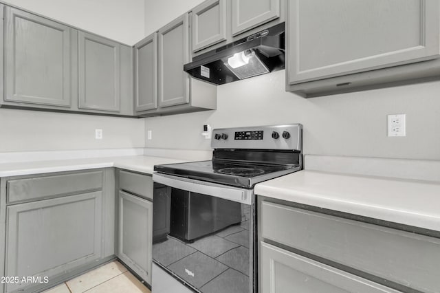 1858 S Ocotillo Dr, Apache Junction, AZ 85120 - kitchen featuring stainless steel electric range, under cabinet range hood, gray cabinets, light countertops, and light tile patterned floors