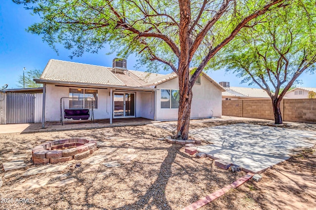 1858 S Ocotillo Dr, Apache Junction, AZ 85120 - rear view of property featuring a fire pit, a patio, stucco siding, and a tile roof