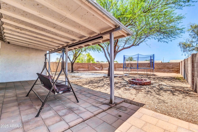 1858 S Ocotillo Dr, Apache Junction, AZ 85120 - fenced backyard featuring a trampoline and a patio area