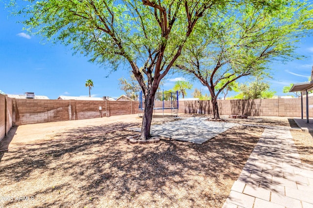 1858 S Ocotillo Dr, Apache Junction, AZ 85120 - fenced backyard featuring a trampoline and a patio