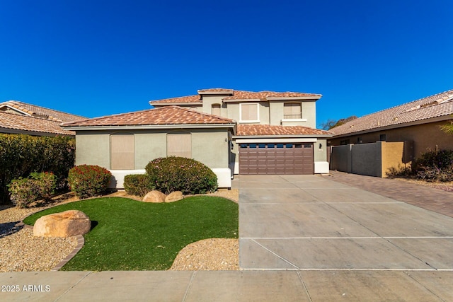 mediterranean / spanish-style house with a garage and a front yard