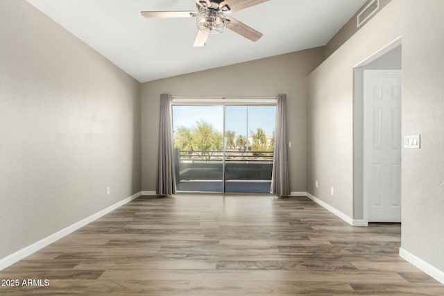 empty room featuring lofted ceiling, ceiling fan, and hardwood / wood-style floors