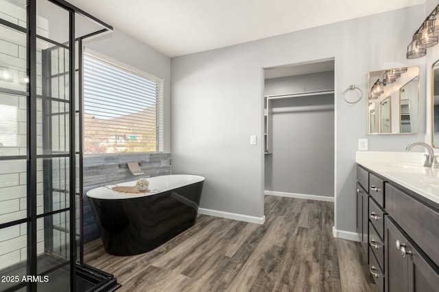 bathroom featuring hardwood / wood-style floors, a bathtub, and vanity