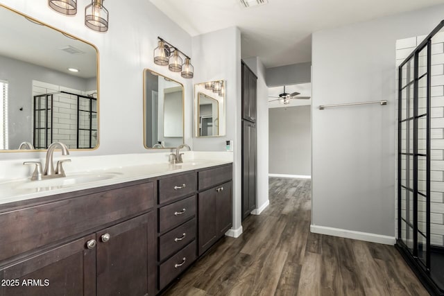 bathroom with ceiling fan, vanity, a shower with shower door, and hardwood / wood-style floors