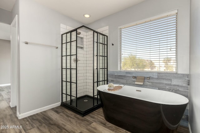 bathroom with hardwood / wood-style floors and plus walk in shower