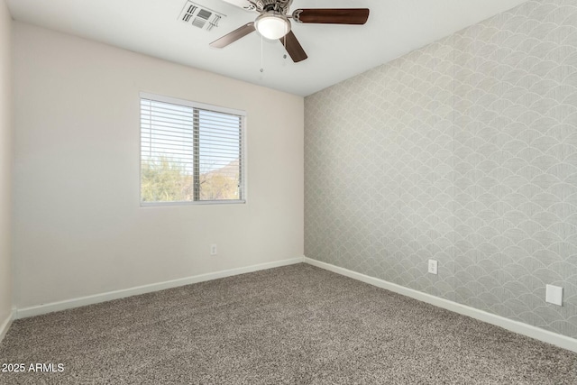 carpeted spare room with ceiling fan