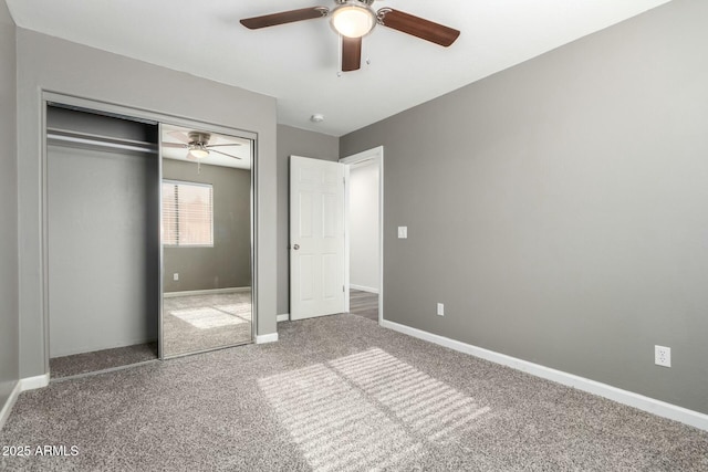 unfurnished bedroom featuring ceiling fan, a closet, and carpet floors