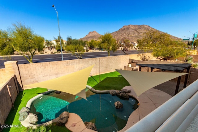 view of community featuring a pool and a mountain view