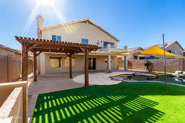 back of property with a lawn, a pergola, a patio area, and a balcony