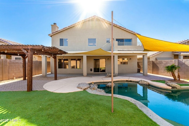 back of house with a patio, a lawn, and a pergola