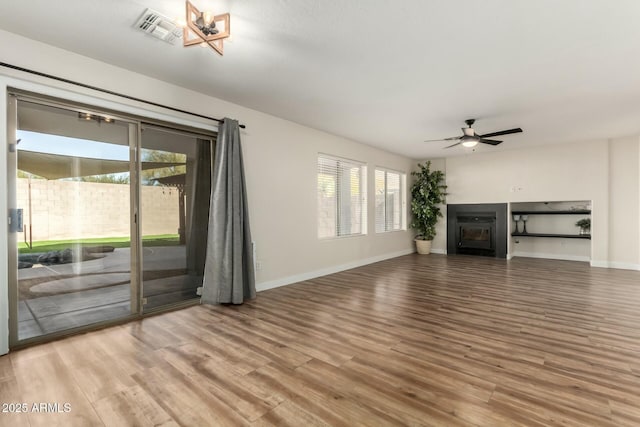 unfurnished living room with ceiling fan and hardwood / wood-style flooring