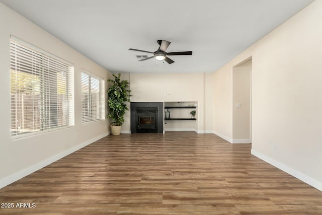 unfurnished living room with ceiling fan and hardwood / wood-style flooring