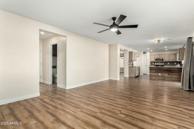 unfurnished living room featuring ceiling fan and hardwood / wood-style floors