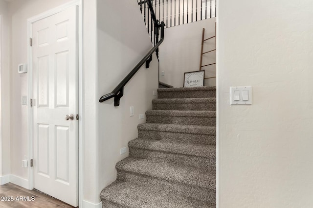 stairs with wood-type flooring