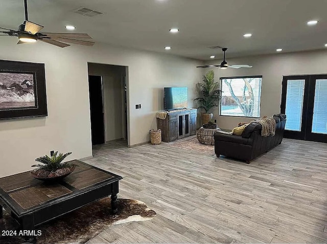 living room with light hardwood / wood-style floors and french doors