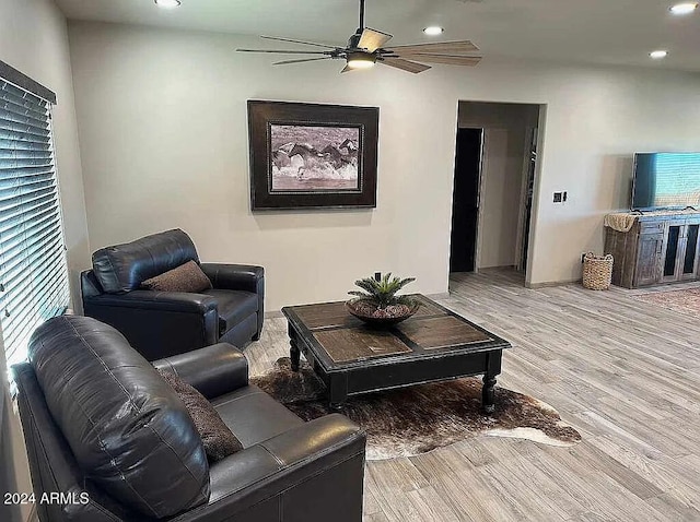 living room featuring light wood-type flooring, a wealth of natural light, and ceiling fan